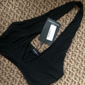 Black PrettyLittleThing halter neck crop top.